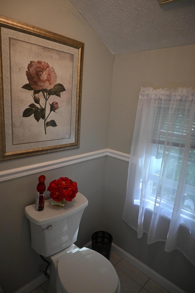1617 Academy Dr, East Stroudsburg, PA 18301 - half bathroom featuring a textured ceiling, tile patterned flooring, and vaulted ceiling