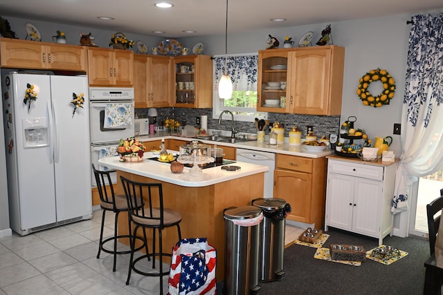 1617 Academy Dr, East Stroudsburg, PA 18301 - kitchen with white appliances, a breakfast bar, glass insert cabinets, decorative backsplash, and recessed lighting