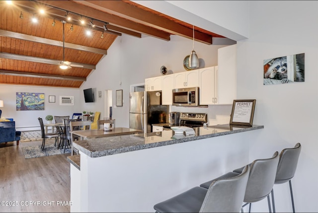 3126 Snowden Dr, Bushkill, PA 18324 - kitchen with appliances with stainless steel finishes, a peninsula, light wood-style floors, white cabinetry, and a ceiling fan
