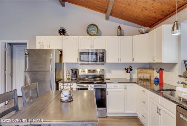 3126 Snowden Dr, Bushkill, PA 18324 - kitchen with stainless steel appliances, wood ceiling, white cabinetry, dark stone countertops, and backsplash