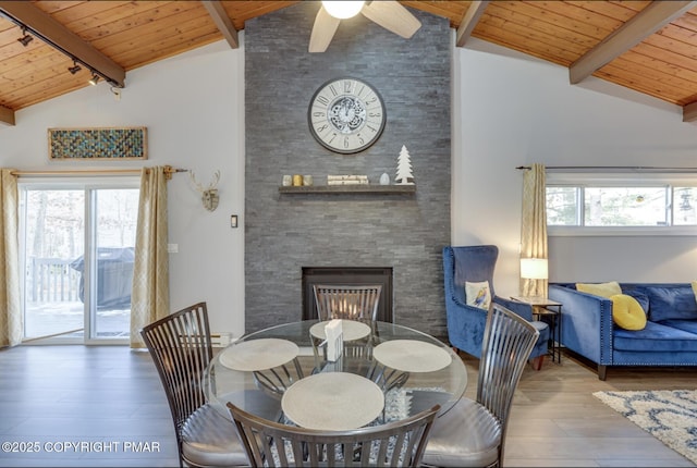 3126 Snowden Dr, Bushkill, PA 18324 - dining space featuring a wood ceiling with exposed beams, wood finished floors, a ceiling fan, high vaulted ceiling, and a stone fireplace