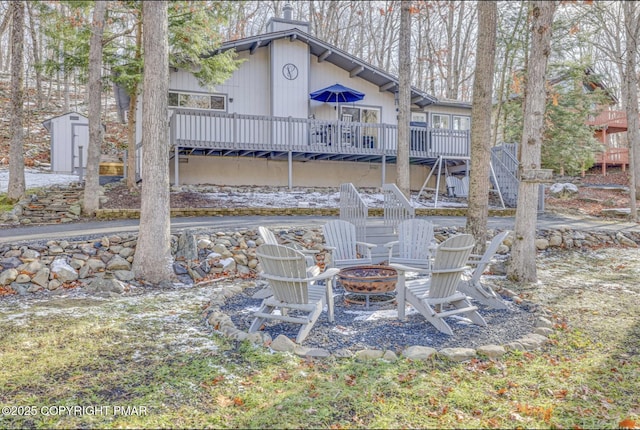 3126 Snowden Dr, Bushkill, PA 18324 - rear view of property with an outdoor fire pit, stairs, a deck, and a chimney
