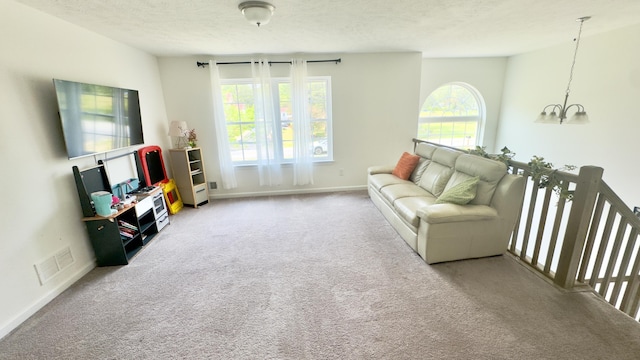 2292 Bismark Rd, Blakeslee, PA 18610 - living room featuring carpet flooring, a chandelier, a textured ceiling, and baseboards