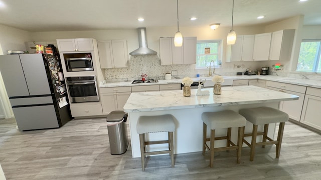 2292 Bismark Rd, Blakeslee, PA 18610 - kitchen featuring stainless steel appliances, wall chimney exhaust hood, healthy amount of natural light, a kitchen island, and recessed lighting