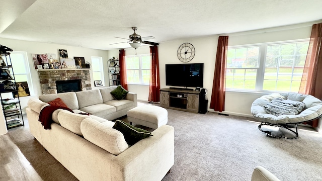 2292 Bismark Rd, Blakeslee, PA 18610 - living area with carpet flooring, plenty of natural light, ceiling fan, a fireplace, and a textured ceiling