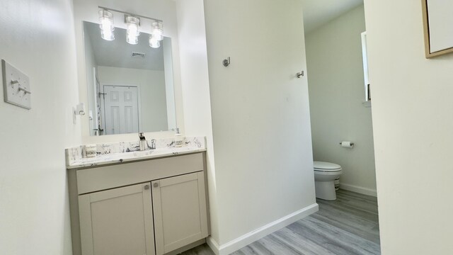 2292 Bismark Rd, Blakeslee, PA 18610 - bathroom with toilet, wood finished floors, vanity, and baseboards