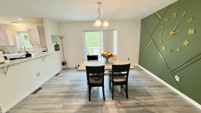 2292 Bismark Rd, Blakeslee, PA 18610 - dining area featuring a chandelier, healthy amount of natural light, light wood-style flooring, and baseboards
