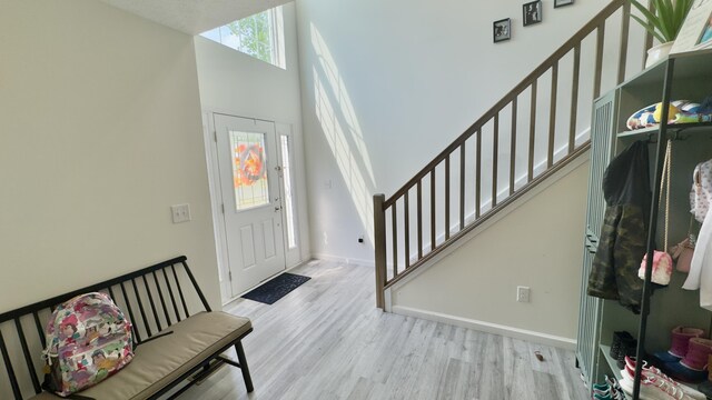 2292 Bismark Rd, Blakeslee, PA 18610 - foyer entrance featuring wood finished floors, stairway, baseboards, and a high ceiling