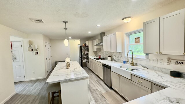 2292 Bismark Rd, Blakeslee, PA 18610 - kitchen featuring stainless steel dishwasher, a sink, gas stovetop, light wood-style flooring, and a kitchen island