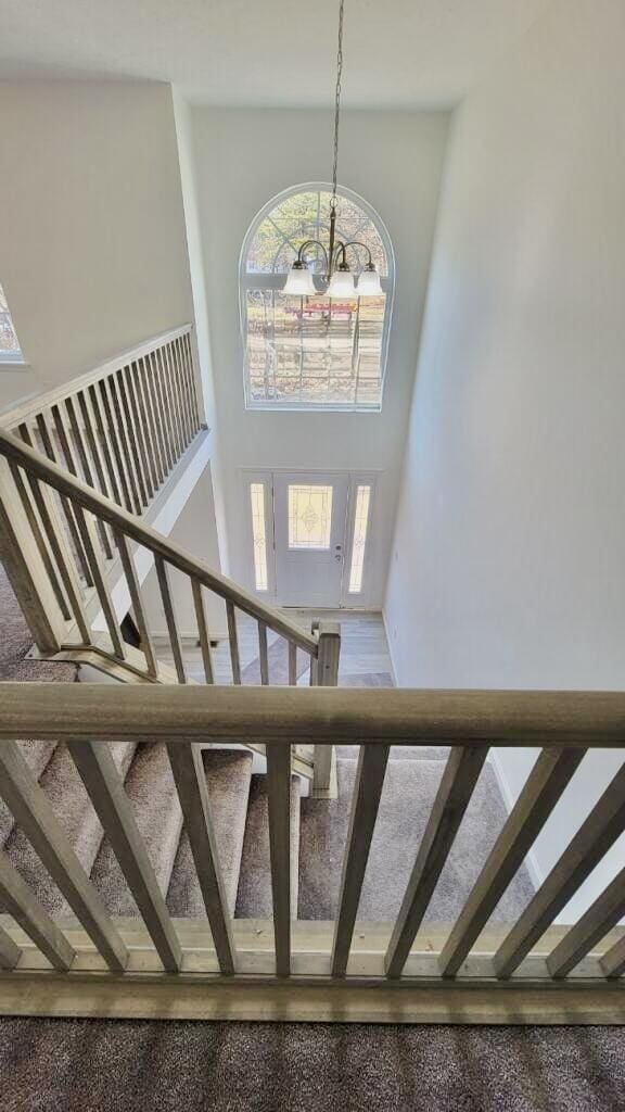 2292 Bismark Rd, Blakeslee, PA 18610 - stairway featuring a chandelier and a towering ceiling