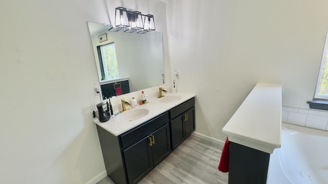 2292 Bismark Rd, Blakeslee, PA 18610 - bathroom featuring double vanity, wood finished floors, baseboards, and a tub to relax in