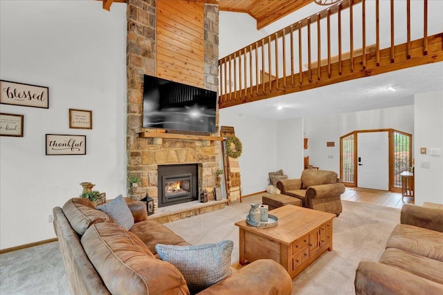 96 Wolf Hollow Rd, Lake Harmony, PA 18624 - carpeted living room featuring high vaulted ceiling, a fireplace, and baseboards