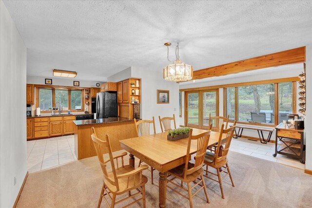 96 Wolf Hollow Rd, Lake Harmony, PA 18624 - dining space featuring light tile patterned floors, a textured ceiling, a chandelier, and light colored carpet