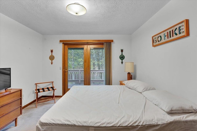 96 Wolf Hollow Rd, Lake Harmony, PA 18624 - bedroom with light carpet, access to outside, a textured ceiling, and baseboards