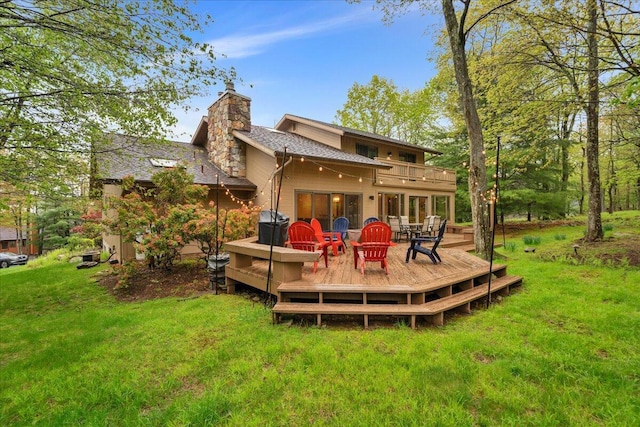 96 Wolf Hollow Rd, Lake Harmony, PA 18624 - back of house featuring a chimney, a yard, a wooden deck, and roof with shingles