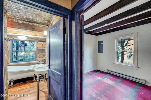 hallway featuring a baseboard radiator, baseboards, wood finished floors, and beamed ceiling