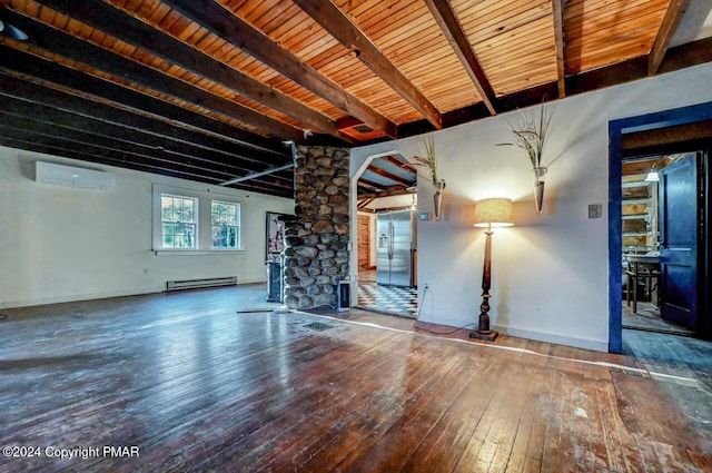 unfurnished living room with a baseboard radiator, decorative columns, wood-type flooring, and beam ceiling