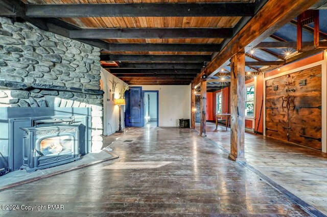 unfurnished living room featuring wood ceiling, beamed ceiling, and hardwood / wood-style flooring