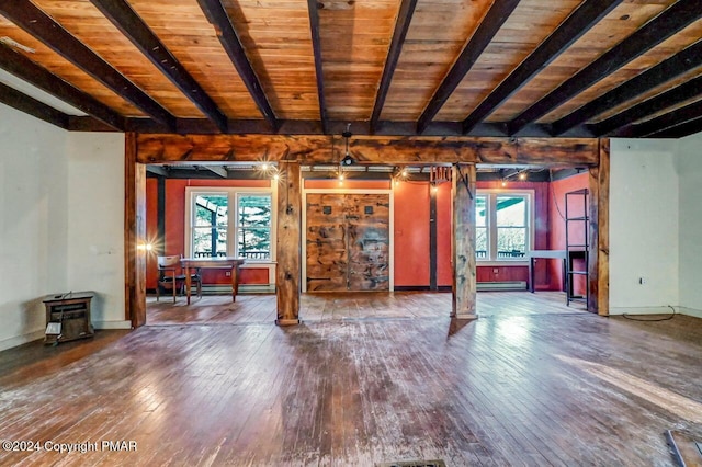 unfurnished living room with wooden ceiling, hardwood / wood-style flooring, a baseboard radiator, and beamed ceiling