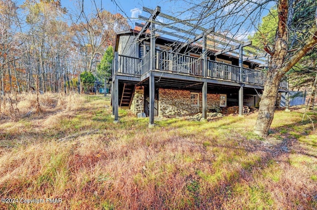 rear view of house with a wooden deck