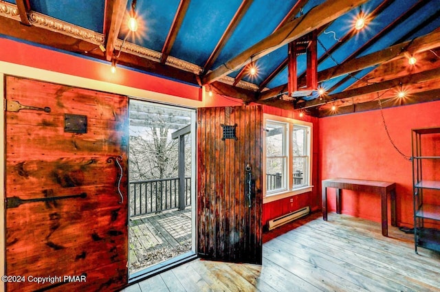 interior space with vaulted ceiling with beams, hardwood / wood-style floors, and baseboard heating