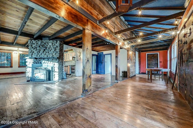 miscellaneous room featuring wood-type flooring and beam ceiling