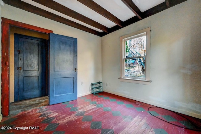 unfurnished room with beam ceiling, hardwood / wood-style flooring, and baseboards