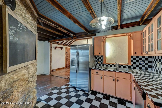 kitchen with tile countertops, beamed ceiling, a sink, stainless steel appliances, and backsplash