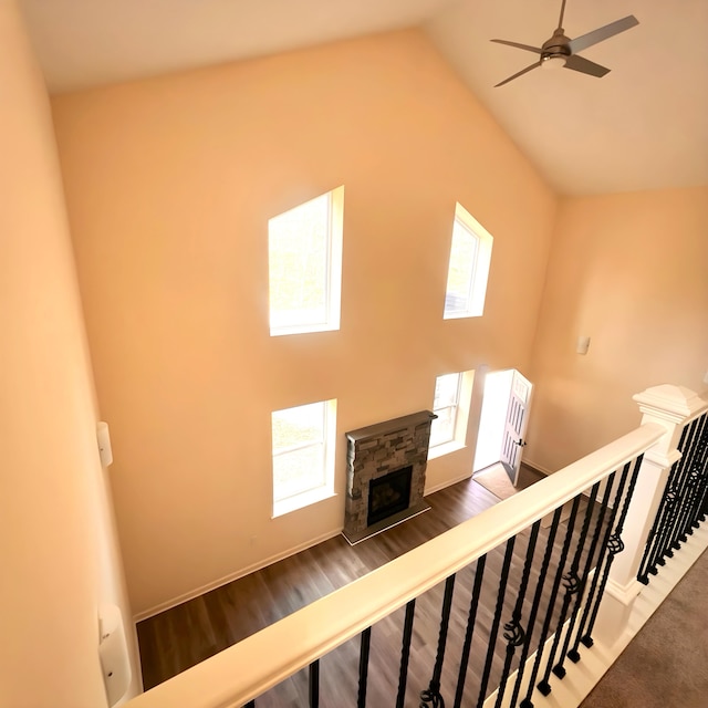 1073 Westside Dr, South Sterling, PA 18445 - stairs with a ceiling fan, high vaulted ceiling, wood finished floors, a stone fireplace, and baseboards