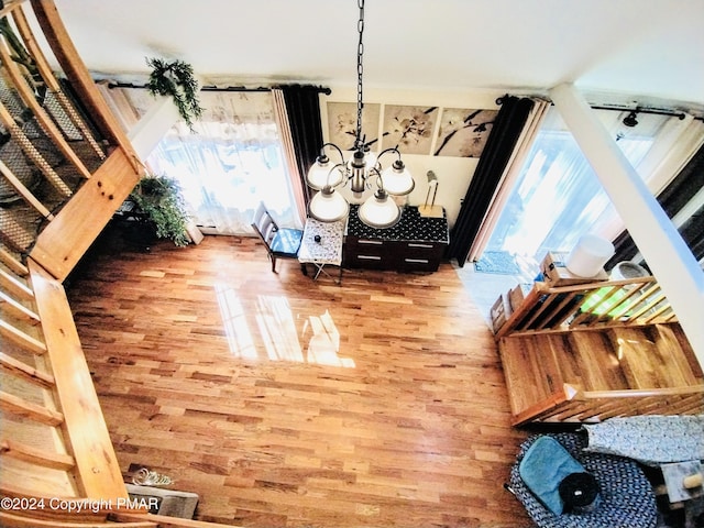 room details with hardwood / wood-style flooring and a chandelier