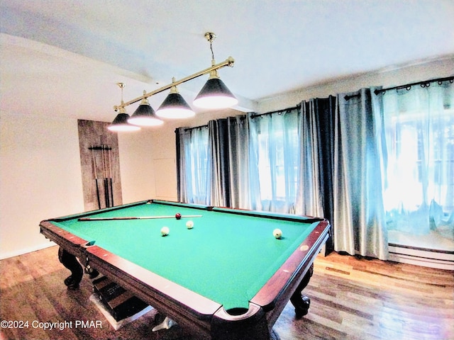 recreation room featuring hardwood / wood-style floors, pool table, and a baseboard heating unit