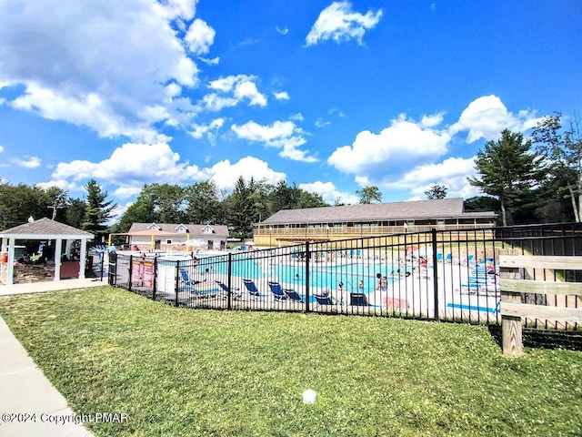 view of swimming pool featuring a gazebo and a lawn