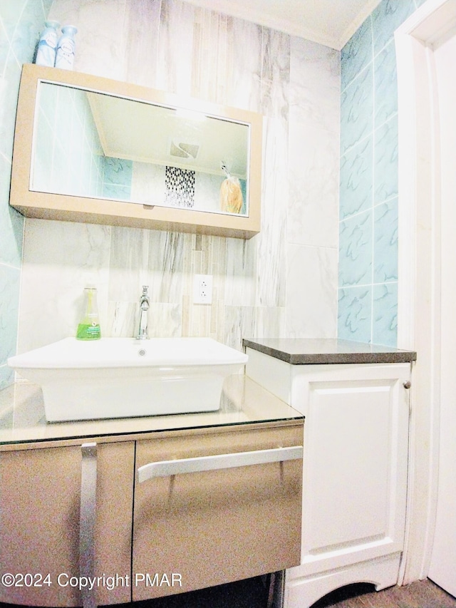 bathroom featuring vanity, tasteful backsplash, and tile walls