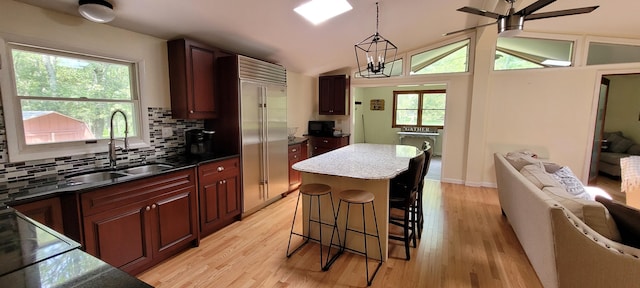 139 Eliot Ln, Albrightsville, PA 18210 - kitchen with ceiling fan, light wood-style floors, decorative backsplash, a breakfast bar, and hanging light fixtures