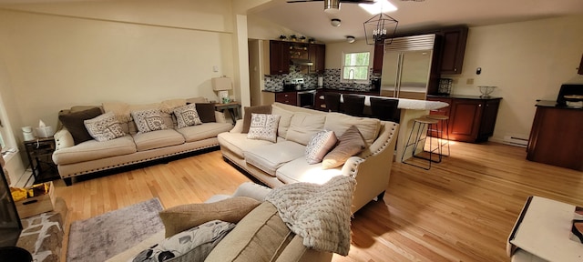 139 Eliot Ln, Albrightsville, PA 18210 - living area with light wood-type flooring, baseboard heating, a ceiling fan, and vaulted ceiling