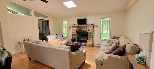 139 Eliot Ln, Albrightsville, PA 18210 - living area with healthy amount of natural light, light wood finished floors, baseboard heating, lofted ceiling, and a stone fireplace