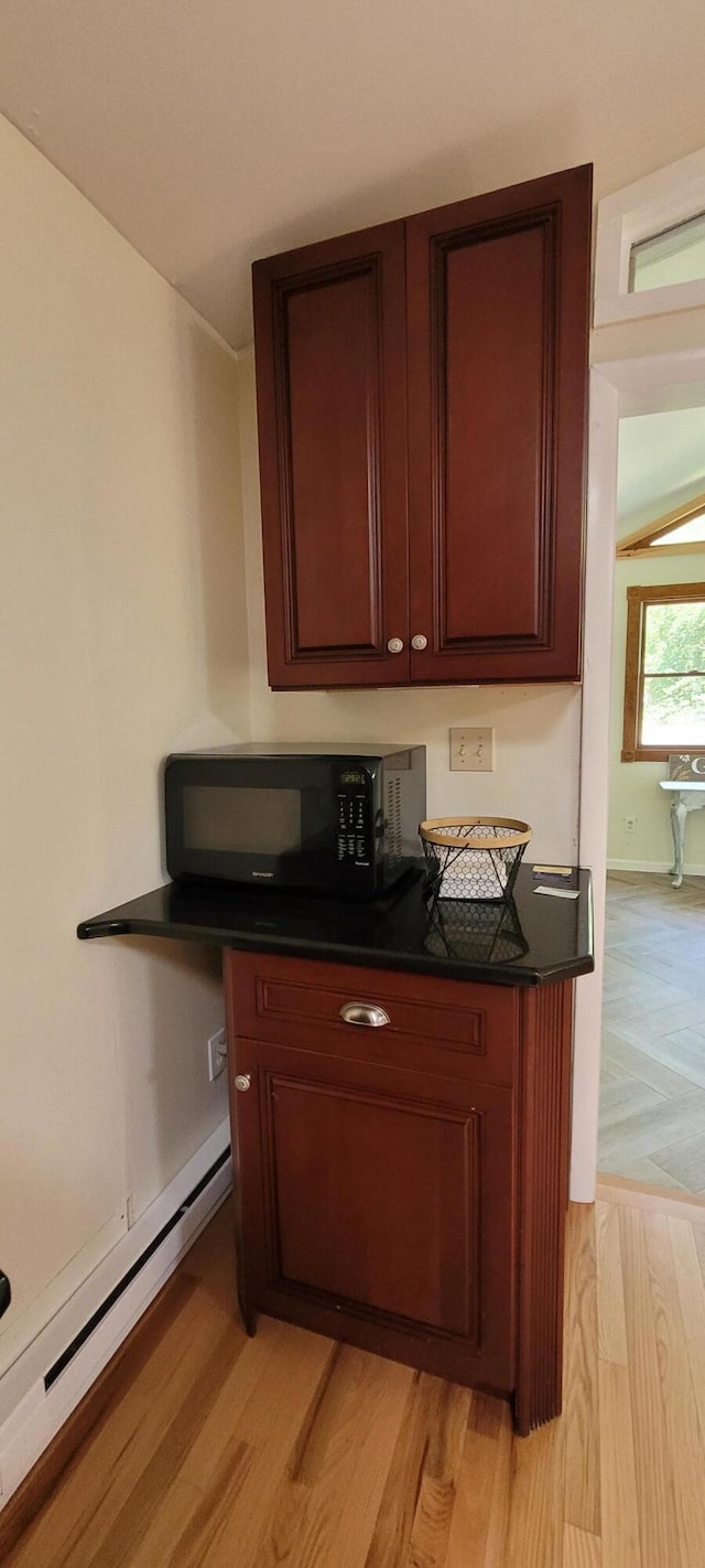 139 Eliot Ln, Albrightsville, PA 18210 - bar area with black microwave, a baseboard heating unit, and light wood-type flooring