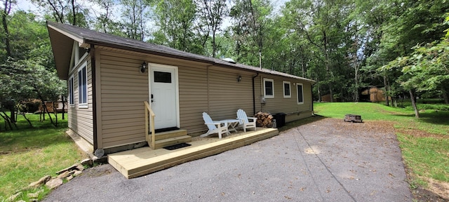 139 Eliot Ln, Albrightsville, PA 18210 - back of house featuring a yard, entry steps, a patio area, view of scattered trees, and an outdoor fire pit