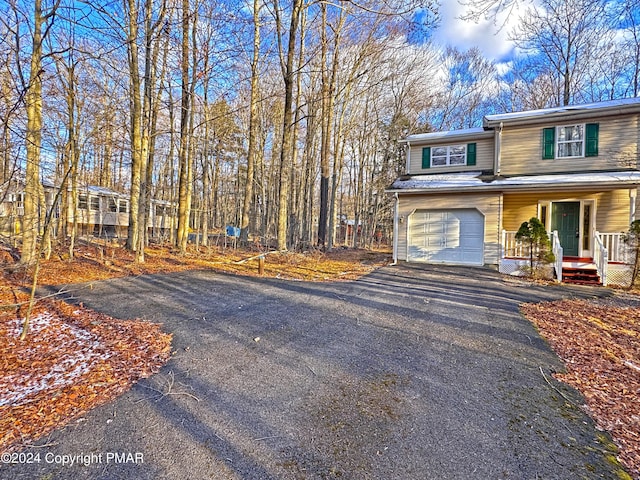 view of front facade featuring a porch and a garage