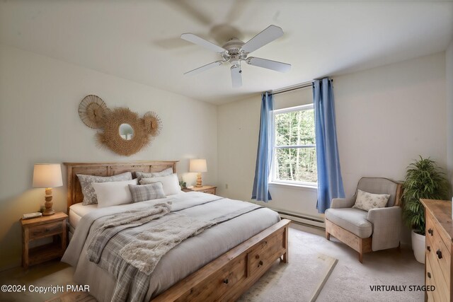 bedroom with ceiling fan, light carpet, and a baseboard heating unit