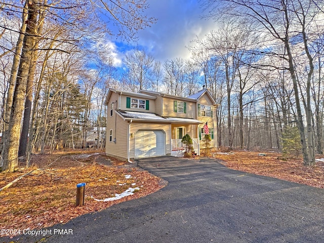 view of property featuring a porch and a garage