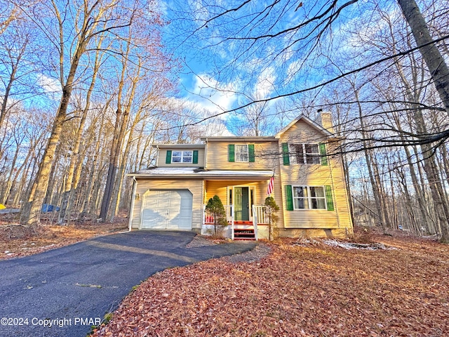 front of property with a porch and a garage