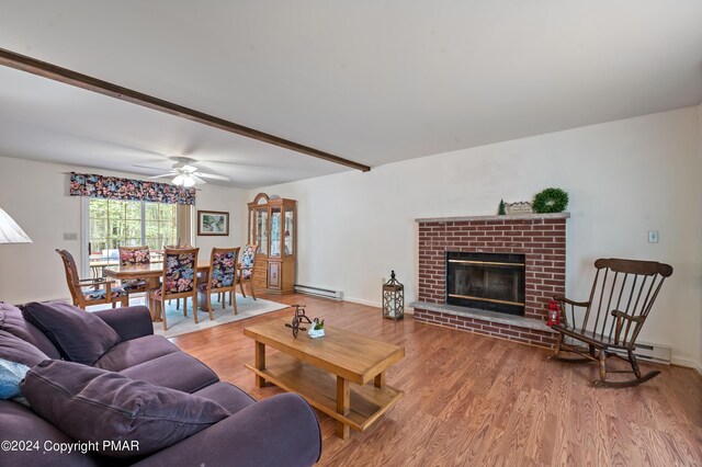 living room featuring hardwood / wood-style flooring, a fireplace, and baseboard heating