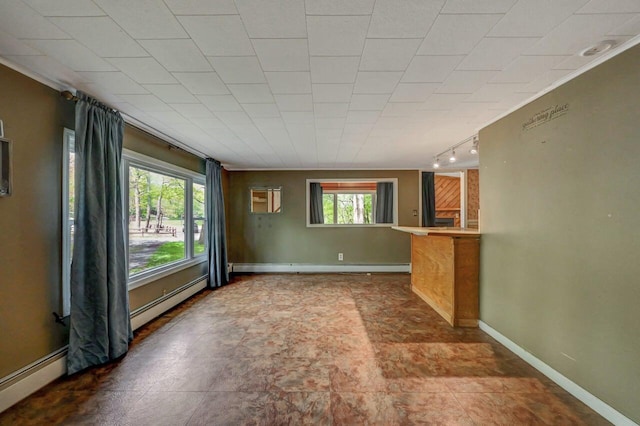 159 Sandstone Dr, Dingmans Ferry, PA 18328 - unfurnished living room featuring rail lighting, a baseboard heating unit, baseboards, and baseboard heating