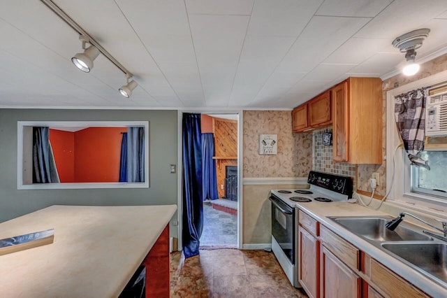 159 Sandstone Dr, Dingmans Ferry, PA 18328 - kitchen with range with electric cooktop, light countertops, track lighting, brown cabinets, and a sink