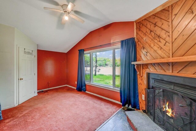 159 Sandstone Dr, Dingmans Ferry, PA 18328 - unfurnished living room featuring lofted ceiling, ceiling fan, baseboards, a large fireplace, and carpet floors