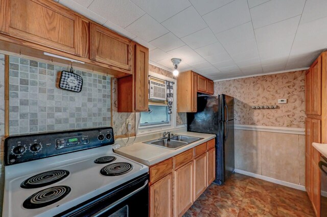 159 Sandstone Dr, Dingmans Ferry, PA 18328 - kitchen featuring electric range oven, a sink, freestanding refrigerator, light countertops, and wainscoting