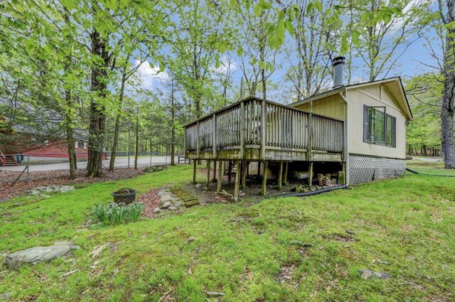 159 Sandstone Dr, Dingmans Ferry, PA 18328 - rear view of house with a yard, an outdoor fire pit, and a deck