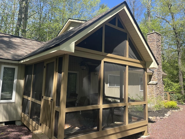 1515 Beech Spring Dr, Pocono Pines, PA 18350 - view of property exterior featuring a sunroom, roof with shingles, and a chimney