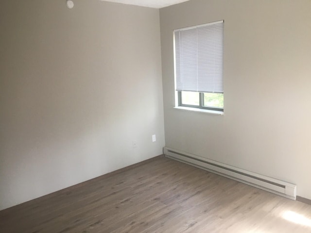 1148 Country Place Dr, Tobyhanna, PA 18466 - empty room with a baseboard radiator and wood finished floors